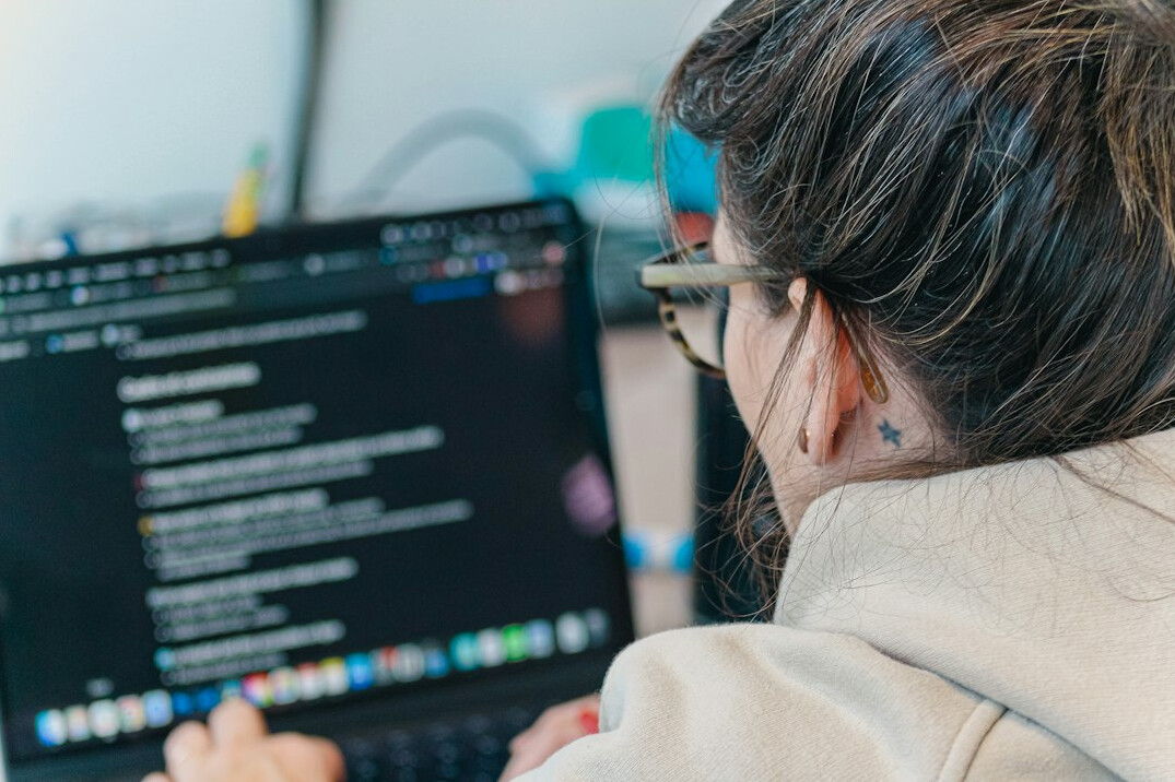 programming student working on laptop