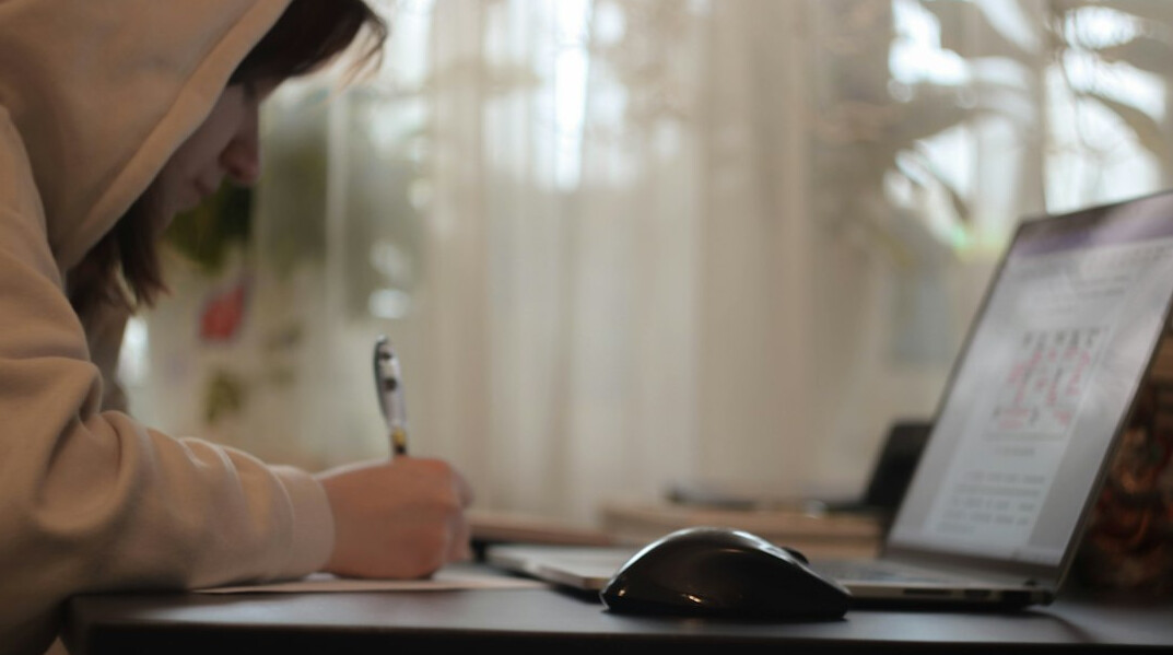 person writing code at home